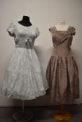 A pale blue and white 1950s dress, having scoop neckline with bow detail and pleated skirt, sold