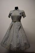 An American 1940s day dress with superb fruit like pattern amidst floral hexagon type pattern,