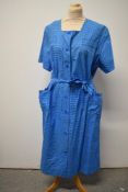 A 1950s French Deadstock day dress in blue checked cotton with button down front and tie fastening