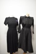 Two 1940s black dresses, one having short sleeves and cummerbund style detail to waist and the other