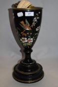A Victorian black ceramic lamp base, having enamelled bird and floral pattern and gilt heightening.