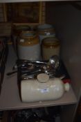 Four vintage earthenware storage jars, a hot water bottle and a collection of flat ware including