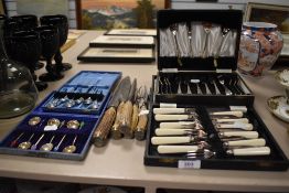 Four boxes of vintage cutlery, including mid century tea spoons with bright moulded plastic coffee