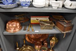 A selection of vintage kitchenalia, including copper jelly moulds, scales, mincer and more.
