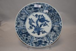 A 19th century CHinese/Japanese plate having blue and white design of flora and motifs, AF.