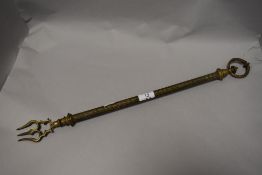 A Victorian telescopic toasting fork having embossed shaft and hoop handle.