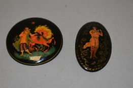 Two 20th century hand painted Russian lacquer brooches one being of very fine quality.