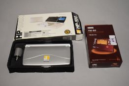 A Korg TM-60 combo tuner metronome in box and a boxed pocket scale.