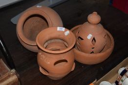 Three terracotta planters and a similar garden ornament.