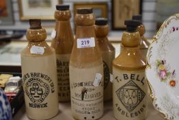 Six earthenware drinks bottles of local interest to Ambleside, Keswick, Whitehaven, Penrith and