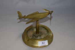 A mid century cast metal ash tray having Spitfire with movable propeller.