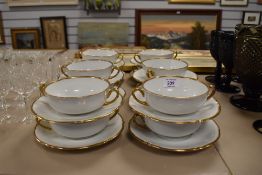 Twelve mid century soup bowls with plates, having white ground with gilt detailing, marked to
