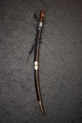 A decorative vintage sword having blue velvet to scabbard and engraved blade.