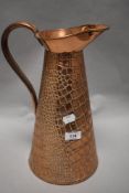 A vintage copper jug having impressed reptile skin design, made in England, J.S & S.