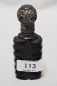 A Victorian amethyst coloured glass perfume bottle with ornate silver lid,AF, hall mark rubbed.