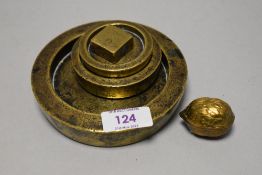 A small vintage hinged brass box of nut form containing two thimbles and four brass weights.