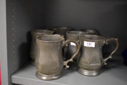 Six antique pewter tankards, each with impressed marks, some monogrammed.