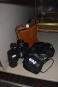 A pair of vintage Proloisirs binoculars with case and two other pairs.