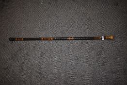 A tribal style walking bamboo walking cane.