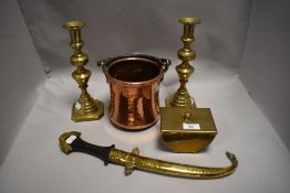 Two brass candlesticks, a hammered brass trinket dish, a copper and brass handled cooking pot and