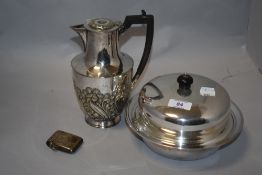 A silver plated coffee pot and a serving dish.