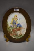 A hand painted plate of oval form, depicting shepherdess to centre.