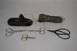 Four pairs of vintage scissors, including decorative sewing scissors and two pairs of early 20th