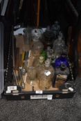 A box of apothecary bottles, measures and similar, including green glass and blue poison bottles.