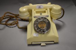 A mid century cream plastic GPO call exchange rotary telephone, having integrated draw to house a