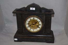 A 19th century Wuttemberg ebonized wood 14 day strike mantel clock, having carved detailing to case,