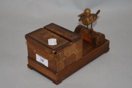 A circa 1930s novelty mechanical cigarette dispenser, having duck which picks up cigarette when