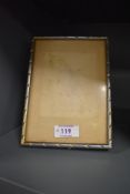 An Indian white metal photograph frame, of rectangular form with rope-twist type decoration,