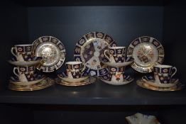 A collection of Royal Crown Derby style tea wares in the Imari palette, cups , saucers and plates to