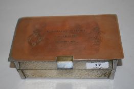 A hammered metal desk top cigarette box, having two hinged compartments over one larger compartment,