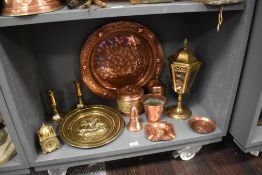 A miscellany of brass and copper ware, including biscuit barrel, lamp (AF) clock and chargers etc.