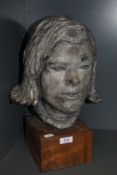 A vintage pottery sculpture on mahogany block,