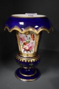 A 19th century footed vase with down turned cuffed neck, having cobalt blue ground and floral