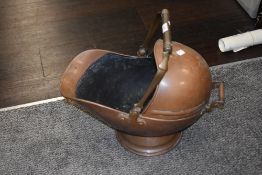 A vintage copper coal scuttle