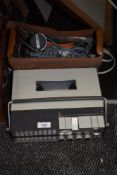 A vintage UHER portable reel to reel and microphone.