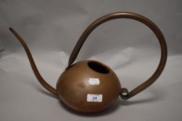A vintage copper Bauhaus style copper watering can.