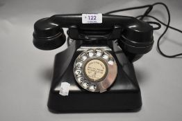 An early 20th century GPO Bakelite telephone set.