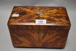 An 19th century tea caddy having tortoiseshell veneered finish, monogrammed to lid and having two