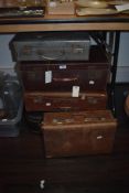 Five vintage suitcases of smaller proportions, including leather effect, ideal for props or