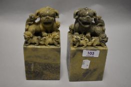 Two Chinese carved soap stone book ends, each depicting five Foo dogs.