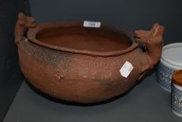 A studio pottery terracotta bowl, having animal studies to sides and impressed border, purchased