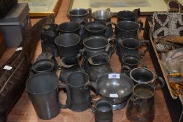 A collection of pewter tankards and similar items, including plated jug, funnel and engraved hip