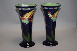 A pair of 1930s H & K Tunstall vases of trumpet form, having decoration of pheasants and foliage.