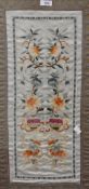 An early 20th century Chinese silk embroidered panel, depicting repeating foliate designs within