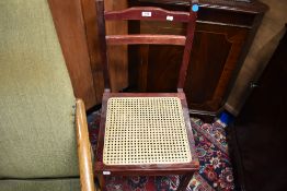 A reproduction stained frame library chair