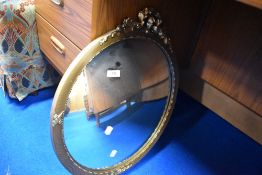 A vintage gilt wall mirror having swag decoration